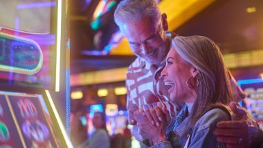 older couple playing slot machines
