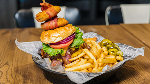 ESPN BET burger with fries and pickles