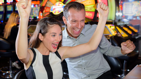 people at slot machine having fun